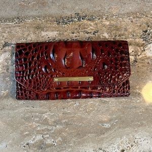 Brahmin wallet in rich brown tone with gold accent.